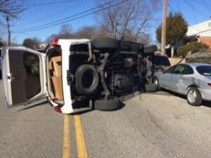 Vehicle on its side in the middle of an intersection after a crash