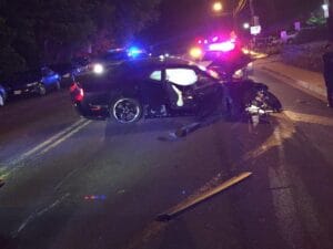 Police cars at a nighttime crash scene on a highway