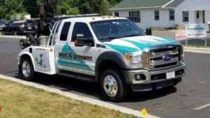 Past & Present Towing wrecker tow truck parked on a residential street