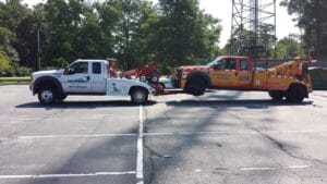 Two Past & Present tow trucks working a roadside tow